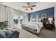 Main bedroom with doors to the patio, ensuite bathroom, and a large bed with decorative pillows at 1287 Buffalo Ridge Rd, Castle Pines, CO 80108