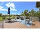 Outdoor patio with a seating area and table with umbrella, overlooking a landscaped yard at 1287 Buffalo Ridge Rd, Castle Pines, CO 80108