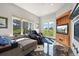 Relaxing sitting area with TV, fireplace, comfortable seating, and a walkout to the yard at 1287 Buffalo Ridge Rd, Castle Pines, CO 80108