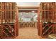 Charming wine cellar with brick floors, rustic bar, and spacious wine storage, perfect for the wine enthusiast at 1287 Buffalo Ridge Rd, Castle Pines, CO 80108