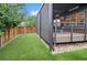 Landscaped backyard with artificial grass and a covered patio, creating a low-maintenance outdoor retreat at 3439 Uinta St, Denver, CO 80238