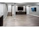 Spacious finished basement offers ample living space, an entertainment center, and light wood-look flooring at 3439 Uinta St, Denver, CO 80238