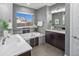 This bathroom features a soaking tub, dual vanity, and modern fixtures at 3439 Uinta St, Denver, CO 80238