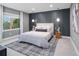 Serene bedroom featuring a comfortable bed, stylish decor, and large window views at 3439 Uinta St, Denver, CO 80238