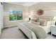 This bedroom features neutral decor and a large window for natural light at 3439 Uinta St, Denver, CO 80238