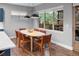 Bright dining area with hardwood floors, stylish chairs, and large windows offering natural light at 3439 Uinta St, Denver, CO 80238