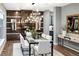 Dining room featuring modern chandelier, glass top dining table, and decorative wood accent wall at 3439 Uinta St, Denver, CO 80238
