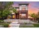 Beautifully landscaped, modern home with brick facade and manicured front yard at sunset at 3439 Uinta St, Denver, CO 80238