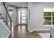 Well-lit foyer with hardwood floors, stairs, and a view to the outside at 3439 Uinta St, Denver, CO 80238
