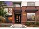 Modern brick home with a stylish front door and professionally landscaped garden beds at 3439 Uinta St, Denver, CO 80238