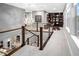 Open hallway with modern railings, decorative chandelier, and views of the staircase at 3439 Uinta St, Denver, CO 80238