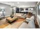 Spacious living room with open floor plan to kitchen and dining area, stylish decor, and ample seating for entertaining at 3439 Uinta St, Denver, CO 80238