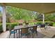 Covered patio area with a dining table, chairs, and views of the backyard at 3144 Stevens N Cir, Erie, CO 80516