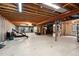 Unfinished basement space with exposed wood beams, open layout, and good lighting at 3144 Stevens N Cir, Erie, CO 80516