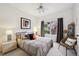 Cozy bedroom featuring a comfortable bed, natural light, and a relaxing wicker chair at 3144 Stevens N Cir, Erie, CO 80516