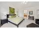 Well-lit primary bedroom with ensuite bathroom and a decorative art piece at 3144 Stevens N Cir, Erie, CO 80516