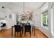Bright dining area featuring hardwood floors and chandelier lighting, adjacent to kitchen at 3144 Stevens N Cir, Erie, CO 80516