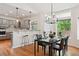 Dining area with hardwood floors and open concept to the kitchen featuring bar seating for entertaining at 3144 Stevens N Cir, Erie, CO 80516