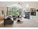 Bright living room featuring vaulted ceilings, large windows, and a cozy fireplace creating an inviting atmosphere at 3144 Stevens N Cir, Erie, CO 80516