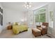 Bright bedroom with a ceiling fan, large window, and relaxing sitting area at 3144 Stevens N Cir, Erie, CO 80516