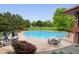Community pool surrounded by lush landscaping and patio seating, perfect for outdoor relaxation at 3144 Stevens N Cir, Erie, CO 80516