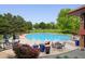 A sparkling community pool surrounded by lounge chairs and well-manicured landscaping on a clear day at 3144 Stevens N Cir, Erie, CO 80516