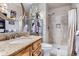 Granite vanity in bathroom with round mirror and tiled shower, offering a fresh and modern look at 19725 Rosewood Ct, Parker, CO 80138