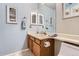 Double vanity in bathroom with updated lighting, fixtures, and decor with blue accent wall at 19725 Rosewood Ct, Parker, CO 80138