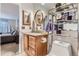 Bathroom featuring granite vanity, round mirror, and view into the carpeted bedroom at 19725 Rosewood Ct, Parker, CO 80138
