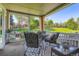 Relaxing covered patio with comfortable seating and views of the green backyard at 19725 Rosewood Ct, Parker, CO 80138