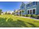 Attractive homes line a well-manicured lawn under a clear blue sky, enhancing community appeal at 19725 Rosewood Ct, Parker, CO 80138