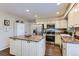 Well-lit kitchen boasts stainless steel appliances, a large island, and plenty of cabinet space at 19725 Rosewood Ct, Parker, CO 80138