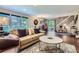 Open-concept living area with comfortable seating, large windows, and a dining space nearby at 19725 Rosewood Ct, Parker, CO 80138