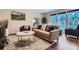 Bright living room featuring a plush sofa, decorative rug, and natural light from large windows at 19725 Rosewood Ct, Parker, CO 80138