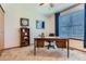 Office features a large wooden desk, neutral carpet, ample lighting, and a bright window at 19725 Rosewood Ct, Parker, CO 80138