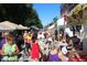 Outdoor street fair with a crowd of people browsing vendor booths under a sunny blue sky at 19725 Rosewood Ct, Parker, CO 80138