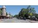 Quaint downtown street with mature trees and sidewalks lined with shops and cafes on a sunny day at 19725 Rosewood Ct, Parker, CO 80138
