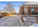 House exterior with steps, wooden railing, and driveway at 10502 Washington Way, Northglenn, CO 80233