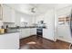 Modern kitchen with white cabinets, granite countertops and stainless steel appliances at 10502 Washington Way, Northglenn, CO 80233