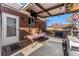 Covered patio with table, chairs, and brick walls at 10502 Washington Way, Northglenn, CO 80233