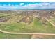 Wide aerial view of rural Colorado property with rolling hills and distant mountain views under a partly cloudy sky at 3794 N State Highway 67, Sedalia, CO 80135