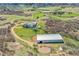 High aerial view of horse property featuring horse barn, fencing, horse ring and mountain views at 3794 N State Highway 67, Sedalia, CO 80135
