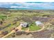 Stunning aerial view of horse property including fenced horse area, horse barn, and home with picturesque mountain views at 3794 N State Highway 67, Sedalia, CO 80135