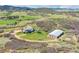 Expansive aerial view of ranch property with house, horse barn and fenced riding area and mountain views at 3794 N State Highway 67, Sedalia, CO 80135