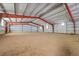 Large barn interior with bright lighting and an expansive dirt floor, ideal for riding or storage at 3794 N State Highway 67, Sedalia, CO 80135