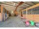 Interior view of barn featuring wooden stalls, dirt flooring, and a workspace area at 3794 N State Highway 67, Sedalia, CO 80135