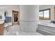 Elegant bathroom features a soaking tub and leads to a walk-in closet for ultimate comfort at 3794 N State Highway 67, Sedalia, CO 80135