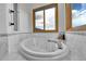 The luxurious bathroom features a modern soaking tub with views of the landscape at 3794 N State Highway 67, Sedalia, CO 80135