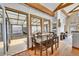 Comfortable dining area with hardwood floors, wood trim, and access to an enclosed porch at 3794 N State Highway 67, Sedalia, CO 80135