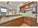 Traditional kitchen with wood cabinets, tiled backsplash, and an efficient layout at 3794 N State Highway 67, Sedalia, CO 80135